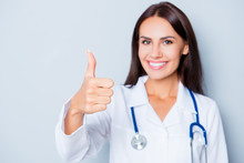 Pretty Smilind Doctor In White Uniform Showing Thumb Up