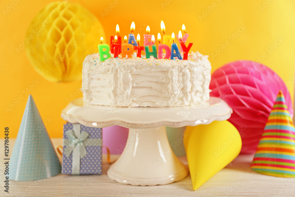 Birthday cake with candles on color background