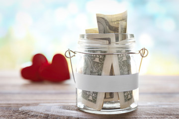 Poster - Glass jar with money on wooden table