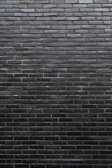 Wall Mural - vertical part of wall consisting of black bricks