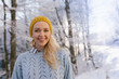 © Myvisuals - Winter portrait of a young smiling woman in a yellow hat on a ba