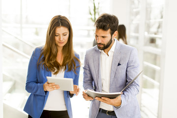 Young business couple using tablet in the office