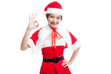 Wall Mural - Asian Christmas Santa Claus girl show Ok sign.