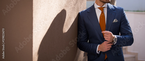 Cuadros en Lienzo Male model in a suit posing outdoors
