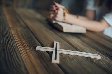 Wall Mural - Womans hands with wooden rosary and Holy Bible