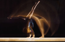 Multiple Exposure Image Of Female Gymnast In Motion On Balance Beam