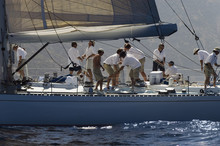 Side View Of Crew Members Working On Sailboat