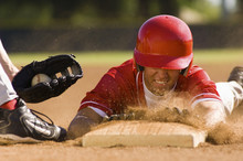 Closeup Of A Baseball Player Sliding To The Base