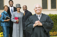 Smiling Preacher In Church Garden Worshipers In Background Portrait