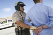 © MDBPIXS - Mature traffic cop arresting man for breaking traffic rules