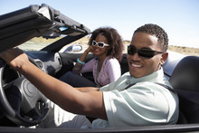 Closeup Of A Happy African American Couple Driving Convertible On Desert Road
