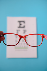 Wall Mural - glasses lying on snellen test chart