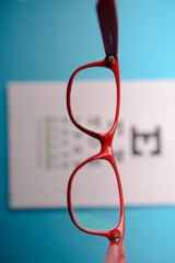 Wall Mural - glasses lying on snellen test chart