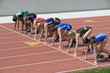 © moodboard - Group of multiethnic female athletes at starting line ready to race