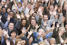 High Angle View Of Group Of Happy Multiethnic People Raising Hands Together