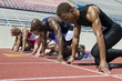 © moodboard - Group of multiracial male athletes at a starting line on racetrack