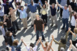 © moodboard - High angle view of multiethnic people forming circle with man standing in center
