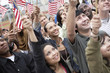 © moodboard - Group of multiethnic people holding up American flags