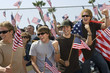 © moodboard - Group of cheerful multiethnic people holding American flags