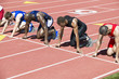 © moodboard - Group of multiethnic male athletics waiting at starting blocks