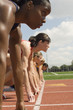 © MDBPIXS - African American woman with competitors at starting line ready to race
