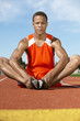 © MDBPIXS - Young male athlete warming up on racing track