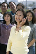 © MDBPIXS - Happy mature woman on a call with people in the background