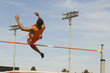 © moodboard - Male athlete performing high jump against sky