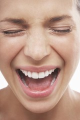 Wall Mural - Closeup of woman screaming with eyes closed