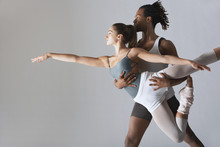 Couple Of Ballet Dancers Posing Over Gray Background