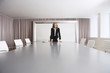 © moodboard - Female business executive standing alone in boardroom