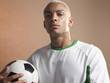 © MDBPIXS - Portrait of a player with football in hand against colored background