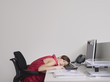 © MDBPIXS - Side view of a female office worker asleep at desk in office