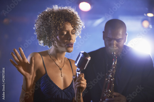 Female singer and saxophonist performing at the jazz club Canvas Print