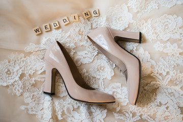 Wedding shoes on wedding dress background