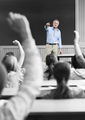professor picking out student for an answer in lecture room