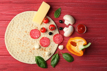 Poster - Raw pizza ingredients on wooden background, top view