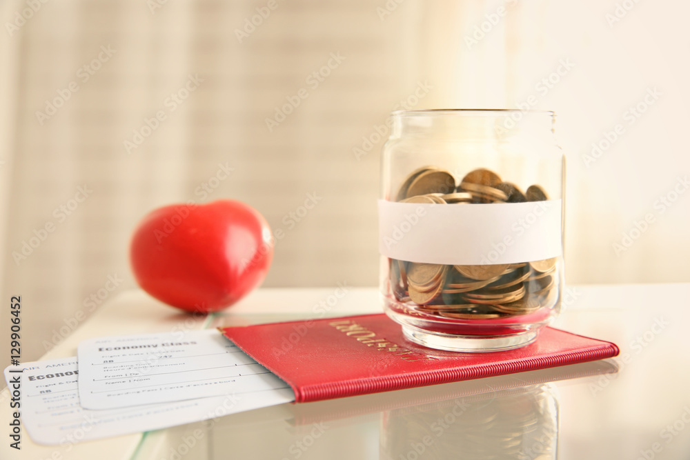 Passport with tickets and money on glass table