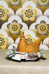 Retro chicken shaped container full of Euros wallpaper