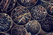 Filtered Screws And Bolts In Tin Can On Wooden Background