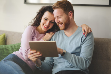 Couple hugging and smiling at home