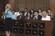 Portrait of a female prosecutor standing by jury box in court
