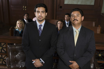 Portrait of a advocate standing with client and people in the background