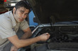 © MDBPIXS - Portrait of a mechanic repairing the engine of car