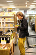 © lado2016 - Man shopping in supermarket reading product information