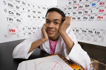 Wall Mural - Portrait of a male student sitting in science laboratory