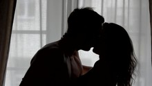 Kiss Of Couple In Slow-mo. Silhouettes Of Man And Woman. Nothing Can Break Us Apart. Passion And Warmth Of Heart.
