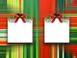 Two square blank frames hanged by red Christmas ribbons against multicolored abstract out of focus illustration background 