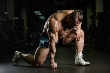 Wall Mural - Brutal strong bodybuilder athletic men pumping up muscles with d