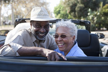 Portrait Of Happy Mature Couple At The Back Seat Of Car Smiling